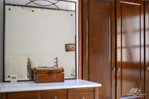 a room with a mirror and a suitcase on a counter at Siridaki Homes Leros in Agia Marina