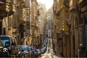 a city street with cars parked on the side of the road at Valletta Stylish City Pad in Valletta