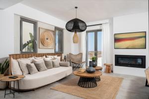 a living room with a couch and a table at Mnḗmē Suites & Villas in Kastrí