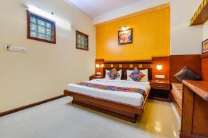 a bedroom with a large bed in a room at FabHotel Royal Residency in Jaipur