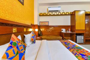 a hotel room with a bed and a desk at FabHotel Royal Residency in Jaipur