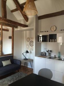 a living room with a couch and a kitchen at Wisteria in Fontainebleau