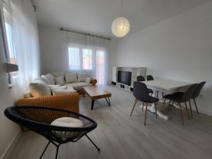 a living room with a couch and a table at Red Hill apartment in Zaboric
