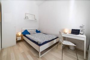 a bedroom with a bed and a desk with a laptop at Cityscape Apartments Mosonyi in Budapest
