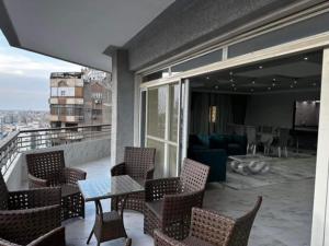 a balcony with chairs and a table and a couch at ٨ شارع عباس العقاد مدينه نصر القاهره in Cairo