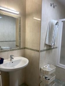 a bathroom with a sink and a mirror at Hostal Andalucia in Nerja