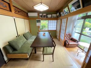 sala de estar con mesa y sofá en Unkai no Sato no Yado en Nosegawa