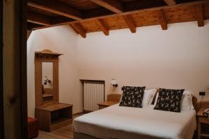 a bedroom with a white bed and a mirror at Principessa Giovanna Boutique Chalet in Roccaraso