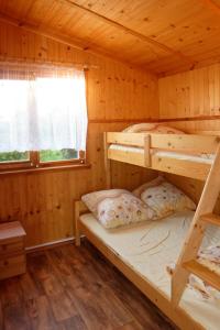 a log cabin with two bunk beds in it at SOLAR WICIE in Wicie