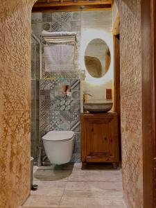 a bathroom with a tub and a toilet and a sink at Saffronia1900 Butik Otel in Safranbolu