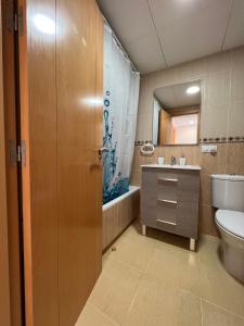 a bathroom with a toilet and a sink and a tub at Ático con piscina privada vistas al mar. in Vera