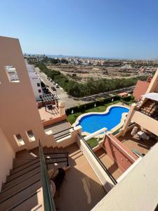 a view from the balcony of a house with a swimming pool at Ático con piscina privada vistas al mar. in Vera