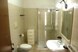 a bathroom with a shower and a toilet and a sink at Villa Patrizia in Taviano