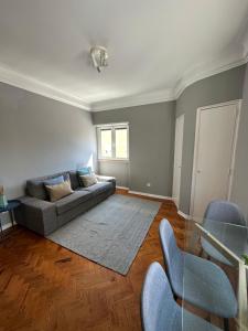 a living room with a couch and a glass table at Rooms to rent in a friendly apartment in Lisbon