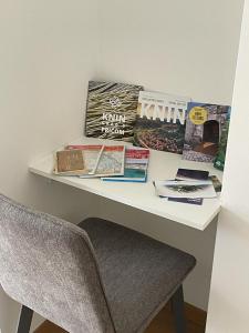 a desk with a chair and books on it at Apartman Stela in Knin