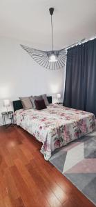 een slaapkamer met een bed met een bloemenbed bij Golden - Éden - superbe 2 pièces de standing en hypercentre in Vichy