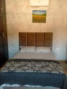 een bed met een bruin hoofdeinde in een slaapkamer bij Villa khaddouj Marrakech in Marrakesh