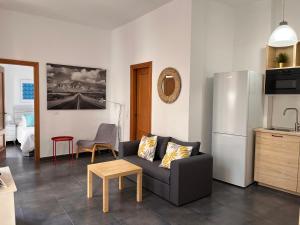 a living room with a couch and a refrigerator at MALAGA CENTRO CATEDRAL in Málaga