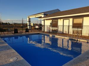 a swimming pool in front of a house at Riata Inn - Marfa in Marfa