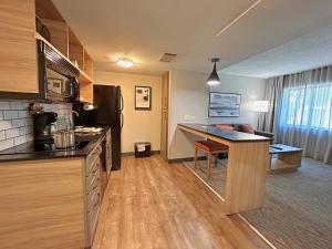 a kitchen and living room with a desk in a room at Candlewood Suites Indianapolis Downtown Medical District, an IHG Hotel in Indianapolis