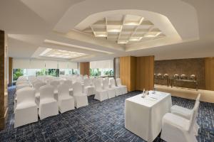 a conference room with white tables and white chairs at Fairfield by Marriott Jaipur in Jaipur