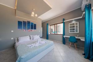 a bedroom with a bed and a desk in it at Luxury Sea View Apartment in Kolimvari in Kolymvari