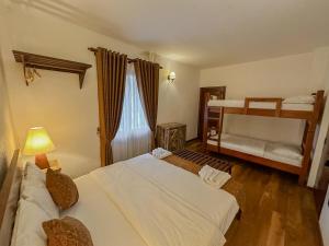 a bedroom with two beds and a bunk bed at Grace in Nuwara Eliya