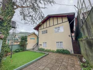 a house with a driveway in front of it at Grace in Nuwara Eliya