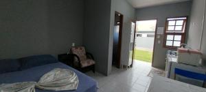 a bedroom with a bed and a door to a yard at POUSADA DONA ELVIRA in Capão da Canoa