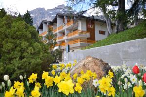 a bunch of flowers in front of a building at Hotel Alex in Leukerbad