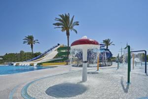 a water park with a slide and a water fountain at Labranda Blue Bay Resort in Ialyssos