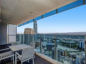 a balcony with a table and a view of a city at H Star Residences-- Paradise Stayz in Gold Coast