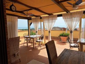 a screened in porch with a table and chairs at Antigua B&B in Porto Potenza Picena