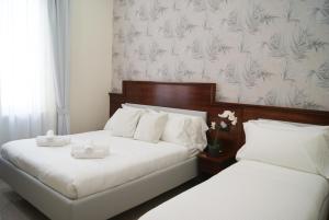 Postel nebo postele na pokoji v ubytování Monti 66 Hotel
