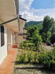 a house with a view of a garden at Soggiorno rilassante in montagna in Riolunato