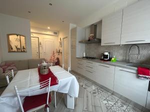 a kitchen and living room with a table and a couch at A CASA DI LETY in Tarvisio