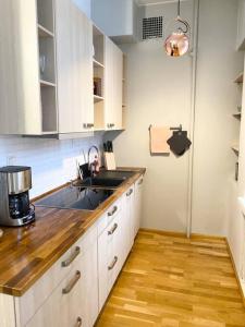 a kitchen with white cabinets and a sink at KALLIO-2 - Kallio with cozy feeling in Helsinki