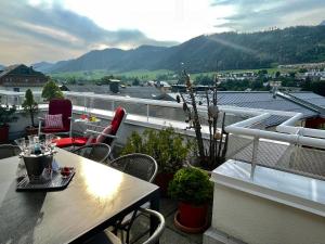 a patio with a table and chairs on a balcony at Appartmenthaus Centro by Schladming-Appartements in Schladming