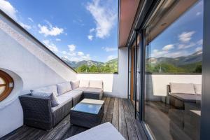 a living room with a couch and a large window at Appartement Gernkogelblick in Wald im Pinzgau