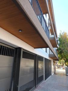 a building with a metal garage door and a balcony at Terrazas de Godoy in Godoy Cruz