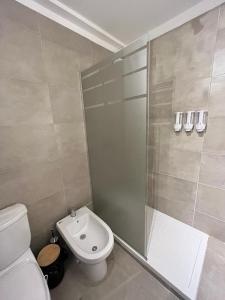 a bathroom with a shower and a toilet and a sink at Terrazas de Godoy in Godoy Cruz