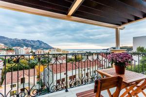a balcony with a table and a view of a city at Apartments Gloria in Budva