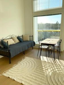 a living room with a bed and a table and a window at TUUSULA Tuusula 15 min drive to Airport in Tuusula