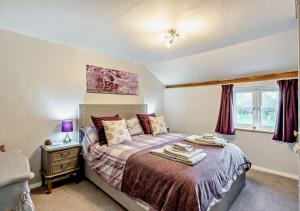 a bedroom with a bed and a dresser and a window at Tiggywinkles in Debenham