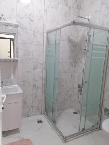 a shower with a glass door in a bathroom at Erme Apart Evler in Dernekpazarı