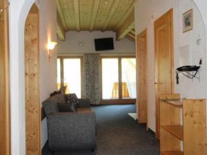 a living room with a couch and some windows at Landhaus Dajana in Gaschurn