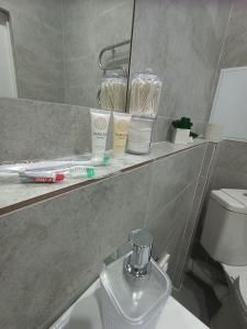 a bathroom with a sink and a mirror at Altyn Dala in Taldykolʼ