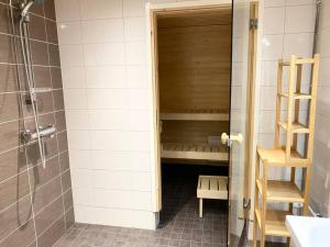 a bathroom with a shower and a sauna at VUOSAARI-2 Pure luxury for 100 m2 in Vuosaari in Helsinki