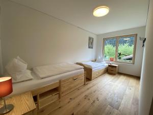 a bedroom with two beds and a window at Haus Albuin in Sankt Gallenkirch