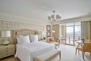 a bedroom with a large white bed and a balcony at Four Seasons Hotel Cairo at Nile Plaza in Cairo